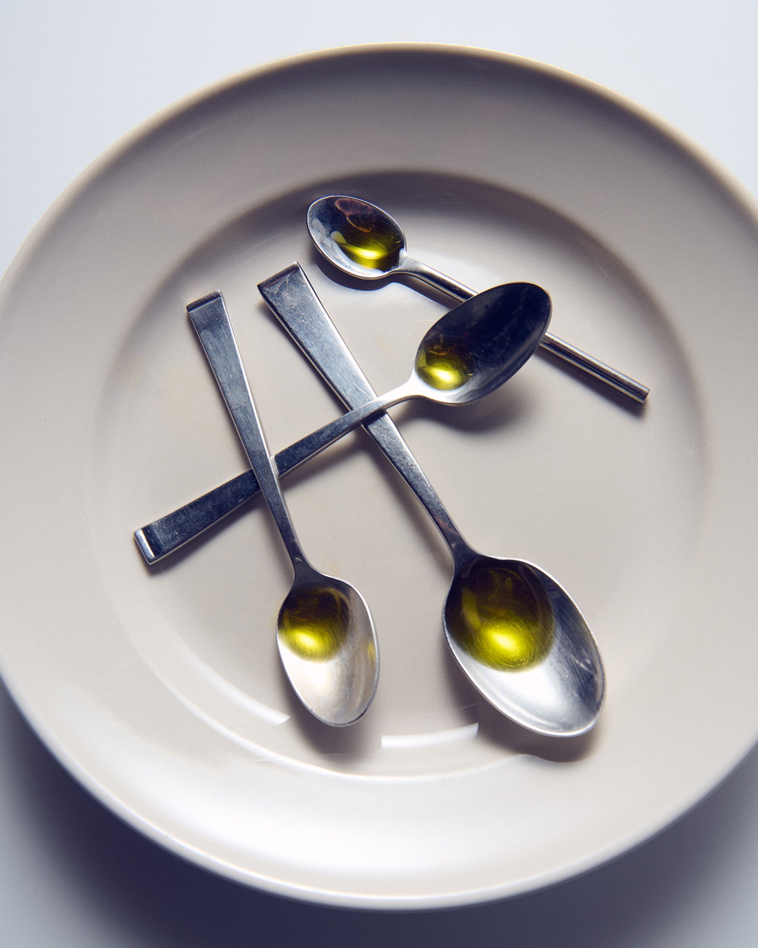 Spoonfuls of olive oil on a plate