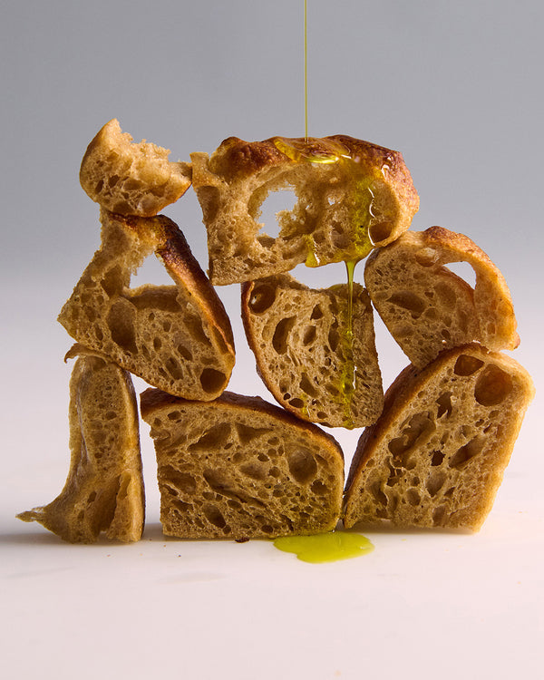 Olive oil dripping on slices of bread